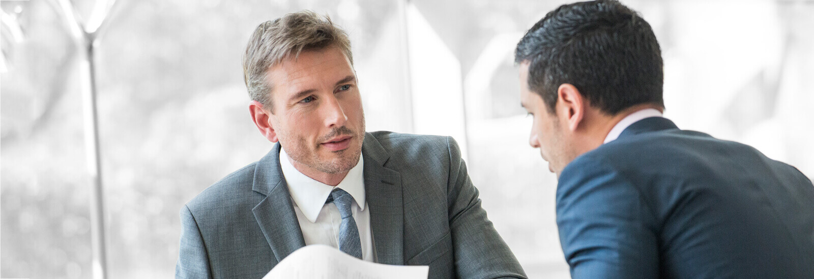 Two financial advisors talking about a plan around a client's portfolio