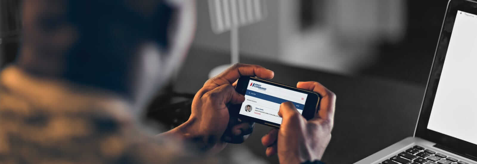 A military service person accessing their bank information on their mobile phone