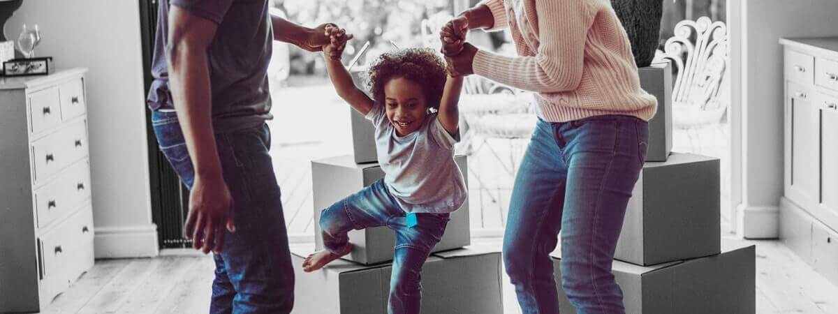 A family playing with their small child in the living room