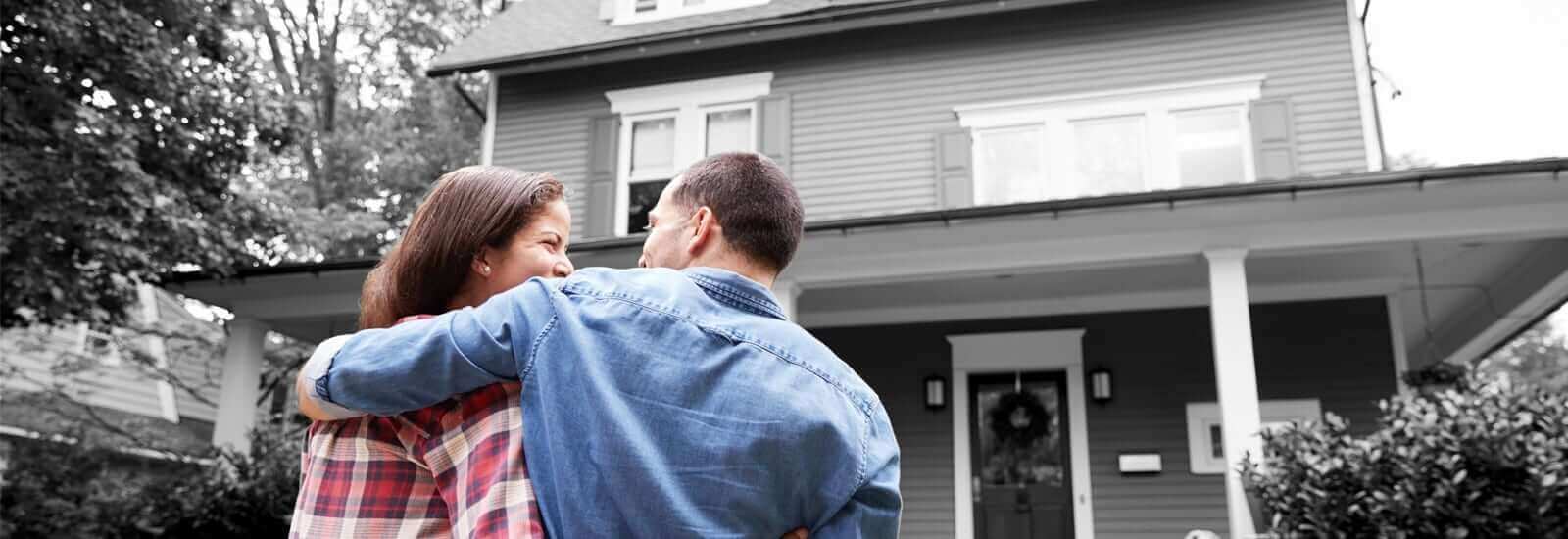 A happy couple moving into their first house