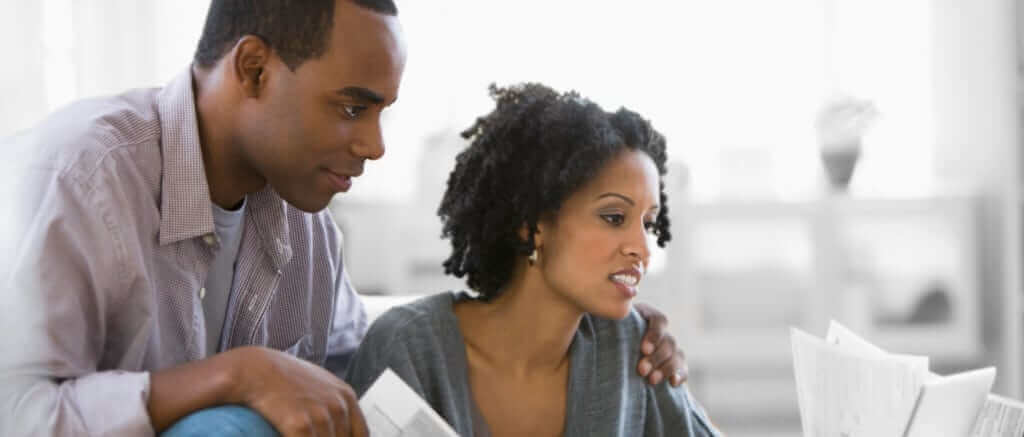 Man and woman looking at bills.