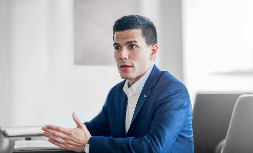 A man in a suit explaining a concept and looking forward intently