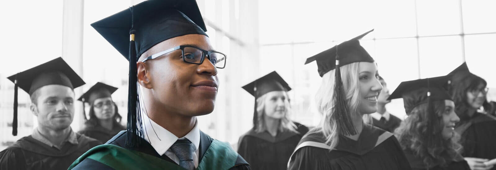 A large group of college graduates waiting during their graduation ceremony